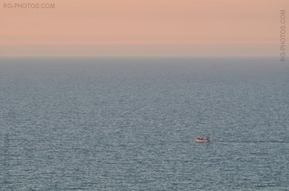 Bateau de pche dans la lumire du soleil couchant